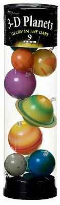 Tall clear tube filled with colorful glow-in-the-dark planet models, including a ringed planet and a blue Earth sphere.