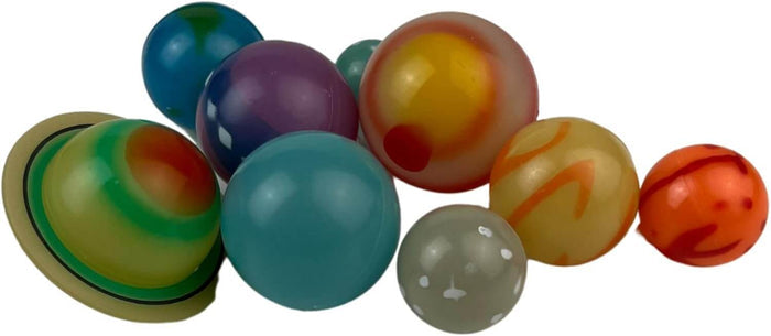 Assorted colorful toy planets in various sizes, including a green ringed planet and spheres with swirls and spots.