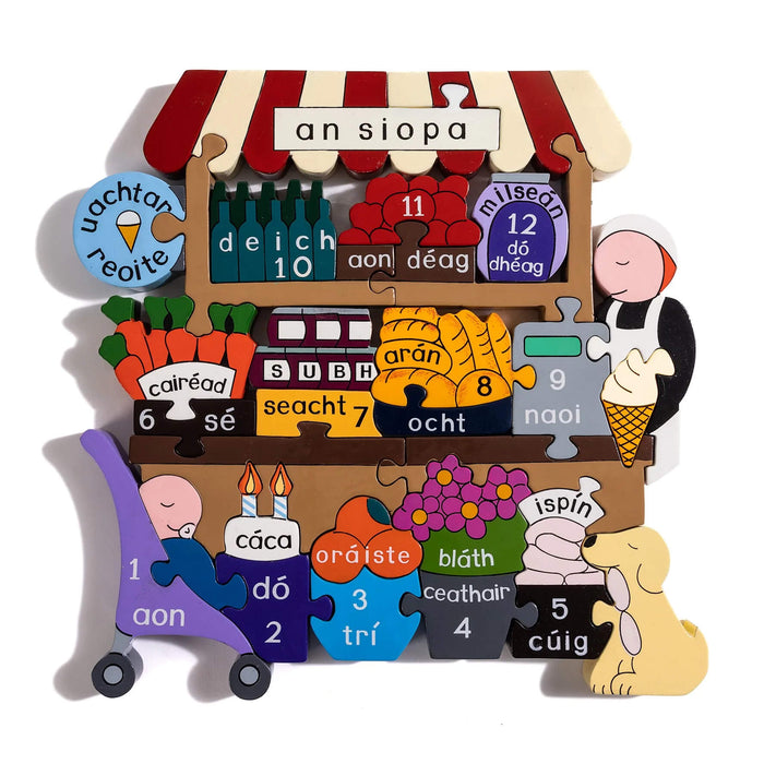 Colorful wooden shop jigsaw puzzle with Irish words and numbers for items like ice cream, bread, and flowers.