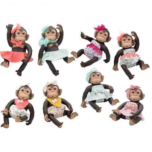 Eight realistic baby monkey dolls wearing colorful patterned outfits and matching headbows in various sitting poses.