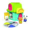 Colorful toy house with a green roof, four bear figurines, and a game spinner with colors and patterns.