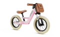 Pink retro balance bike with cream tires, brown leather seat, and a matching front-mounted handlebar bag.
