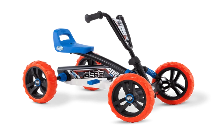 Four-wheel pedal go-kart with off-road orange tires, black frame, blue seat, and visible blue suspension springs.