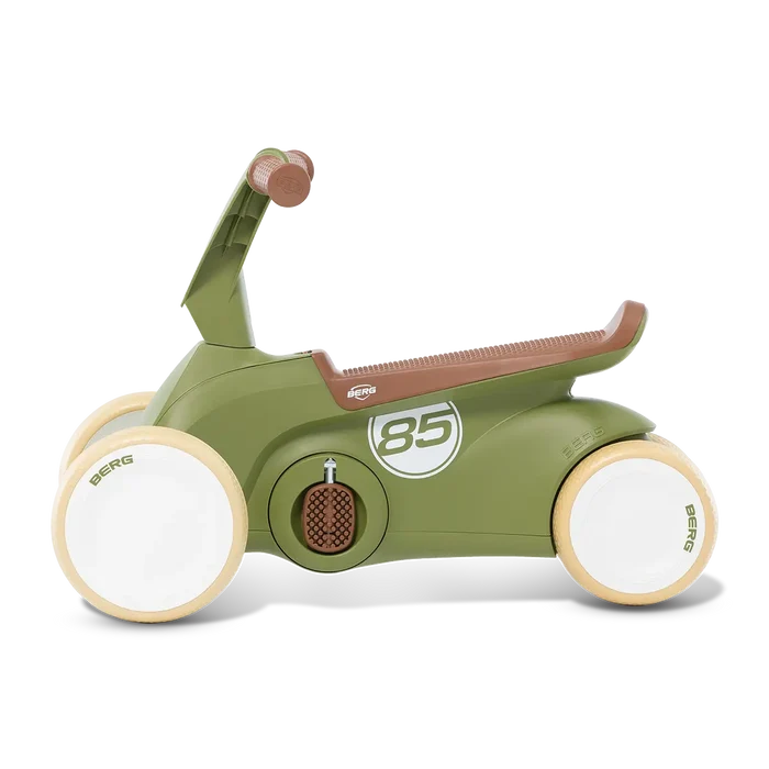 Olive green four-wheeled ride-on toy with brown seat and grips, white wheels, and a white number 85 racing graphic.
