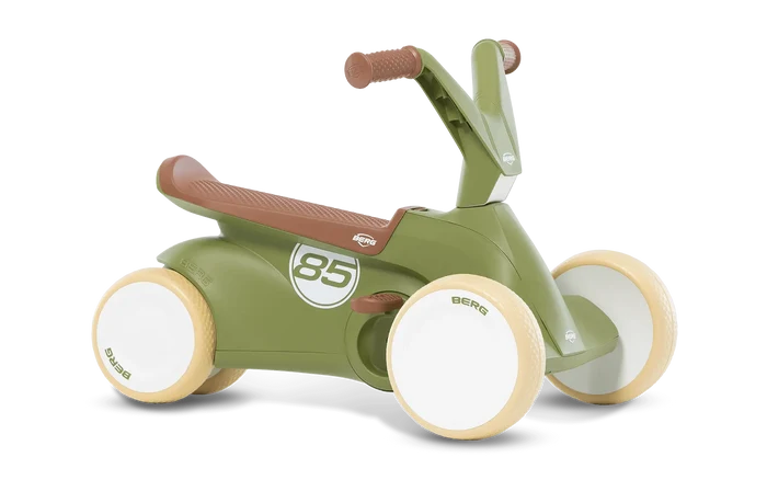 Retro olive green child's ride-on with four cream wheels, brown textured seat, and white 85 graphic on the side.