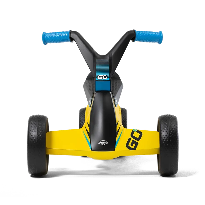 Front view of a yellow and black four-wheeled ride-on toy with blue handlebar grips and thick textured tires.