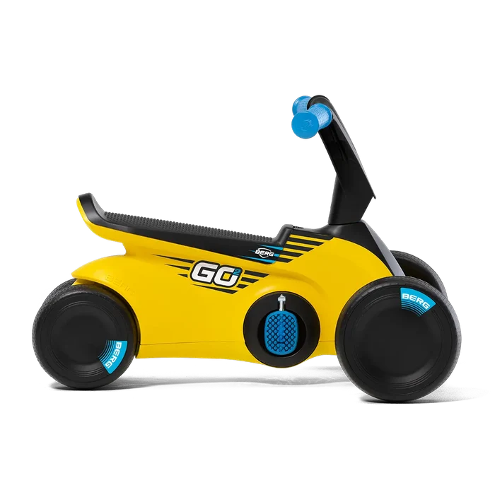 Yellow toddler ride-on with four black wheels, blue textured pedals, blue grips, and a long black contoured seat.