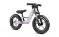 Purple balance bike with chunky knobby tires, black front forks, and white Berg logo on the frame.