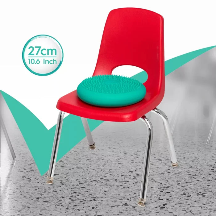 Teal round sensory wiggle cushion with nubs on a red chair. Graphic shows 27cm 10.6 inch diameter.