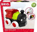 Colorful red, green, and black toy steam engine with white wheels inside red and white BRIO product packaging.