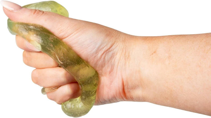Hand squeezing and stretching translucent yellowish-green fidget putty filled with small beads.