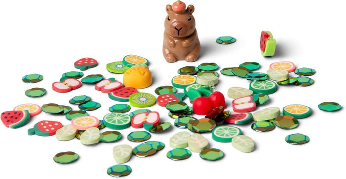 Brown capybara figurine surrounded by colorful fruit-shaped charms and small green gems on a white background.