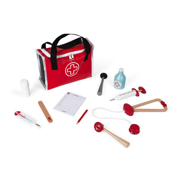 Red fabric medical bag surrounded by wooden toy tools including a stethoscope, syringe, and thermometer.