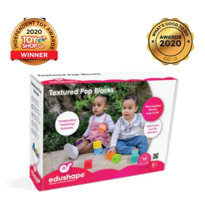 Pink and white Edushape box showing toddlers playing with colorful, square textured blocks and 2020 award seals.