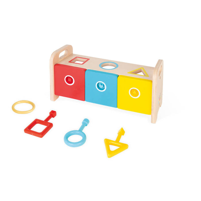 Wooden shape sorter with red, blue, and yellow drawers, matching colored keys, and geometric cutouts on top.