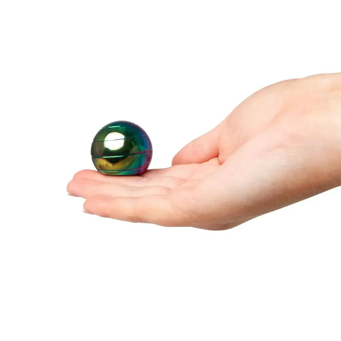 Small iridescent metallic sphere with horizontal rings held in an open hand.