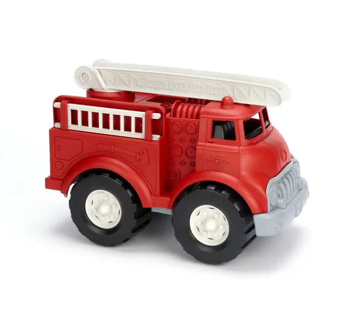 Red toy fire truck with white extendable roof ladder, side ladder, and chunky black tires with white hubs.