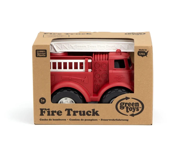 Red plastic toy fire truck with a white ladder and chunky tires, packaged in a brown cardboard box.