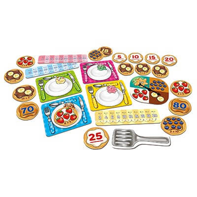 Pancake-themed math game with colorful plate cards, numbered tokens, a spinner, and a silver plastic spatula.