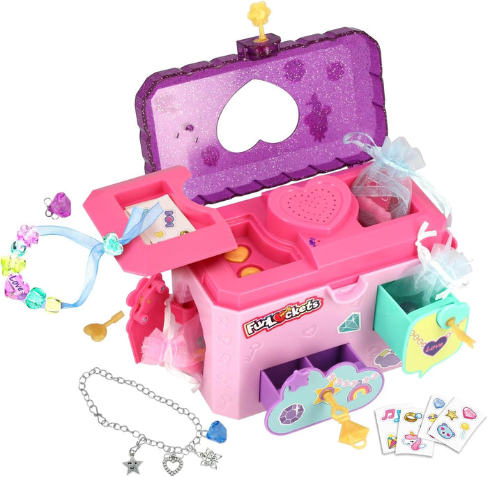 Open pink and purple toy jewelry box with secret compartments, message recorder, charms, stickers, and yellow keys.