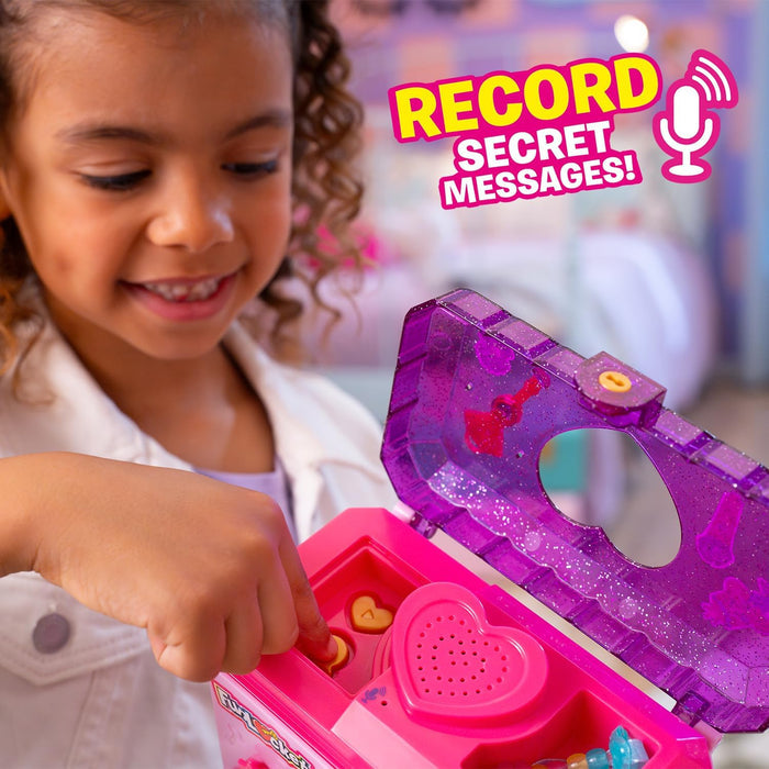 Girl using a pink and glittery purple toy jewelry box with a heart-shaped speaker and translucent lid.