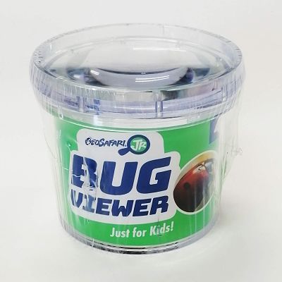 Clear plastic cylindrical container with a magnifying lid and green label with a ladybug, sealed in shrink-wrap.