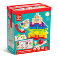 A teal storage tub displaying 80 colorful wooden building blocks, an activity booklet, and a red ball and track.