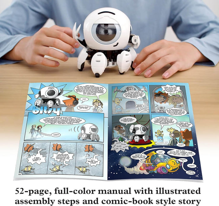 White spherical robot with jointed legs next to an open colorful comic book manual on a wooden table.