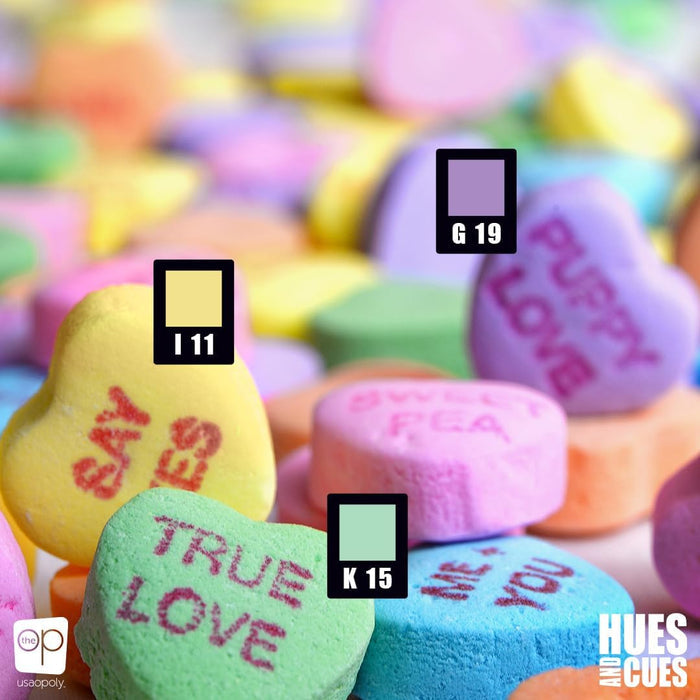 Pastel conversation hearts with matching color swatches G 19, I 11, and K 15 from the Hues and Cues game.