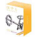 Two interlocking silver metal keys on a yellow and white Huzzle Cast Key II level 2 puzzle box.