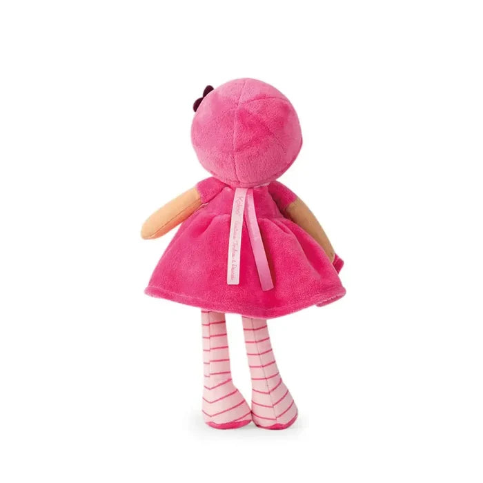 Rear view of a pink plush doll wearing a bright pink dress and pink-and-white striped leggings.