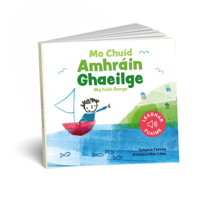 Square board book with green Irish title, child in a red sailboat on blue water, and a red sound book icon.