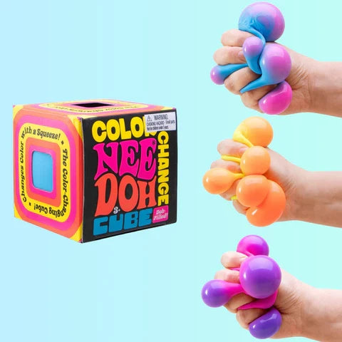 Colorful box next to hands squeezing squishy cubes that change from blue to pink, yellow to orange, and pink to purple.