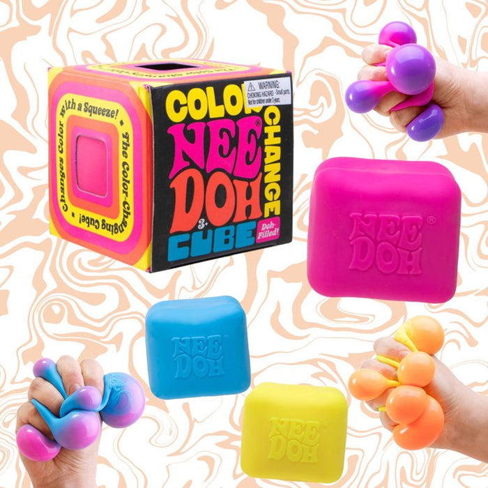 Pink, blue, and yellow squishy cubes and packaging; hands squeeze them to reveal vibrant, color-changing bubbles.