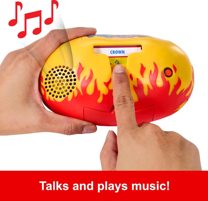 Hands holding an oval yellow and red flame-patterned toy with a speaker, button, and a card labeled CROWN.