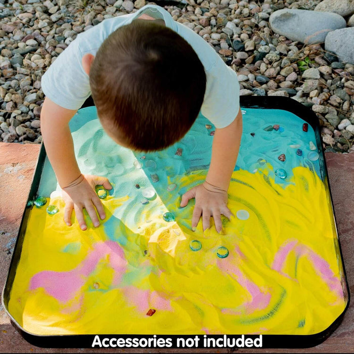 Large black octagonal sensory play tray filled with colorful sand and glass gems, shown with a child playing.