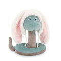 Coiled green and grey plush snake wearing a fuzzy white bunny ear hat with pink inner ears and a grey forked tongue.