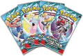 Four teal Pokémon booster packs fanned out, featuring character art of Lillie, Iono, and N on foil packaging.