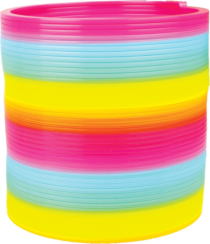 Compressed plastic rainbow coil toy with stacked bands of pink, light blue, green, yellow, and orange.