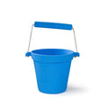 Bright blue silicone toy bucket with white rope handle, padded grip, and embossed puzzle piece logo.