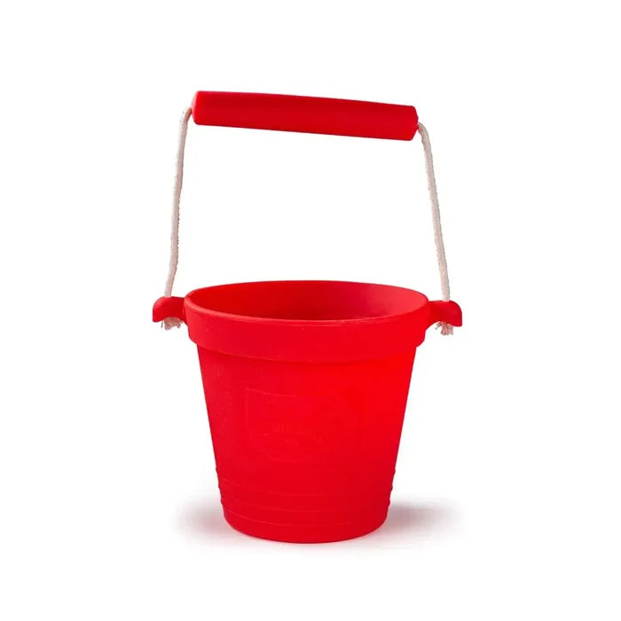 Red silicone activity bucket with a sturdy white rope handle and easy-to-hold red grip.