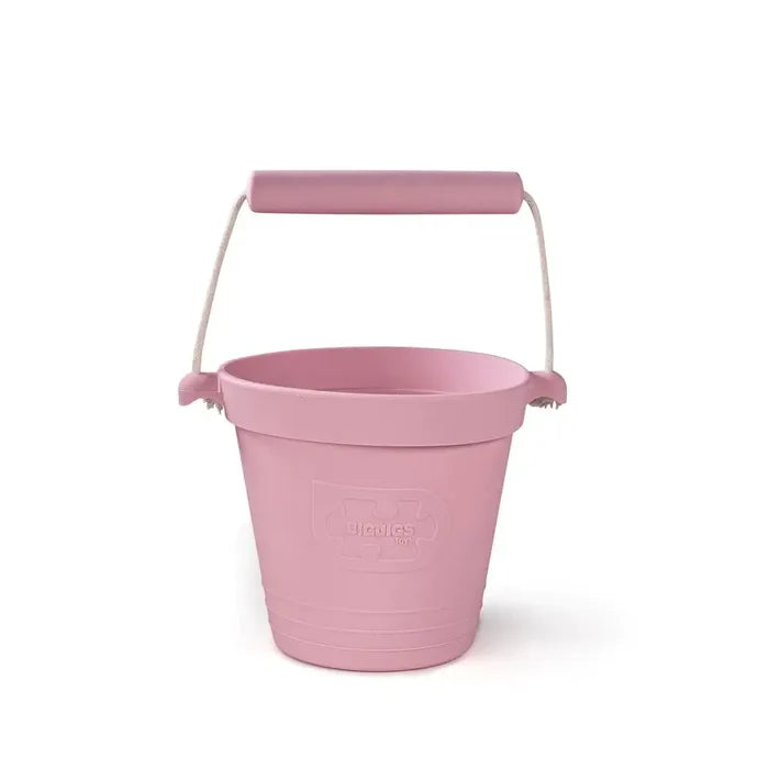 Pink silicone bucket with a rope handle, matching pink grip, and an embossed logo on the front.