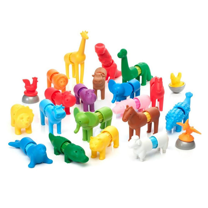 Collection of colorful, modular magnetic toy animals like a yellow giraffe and green elephant on a white background.