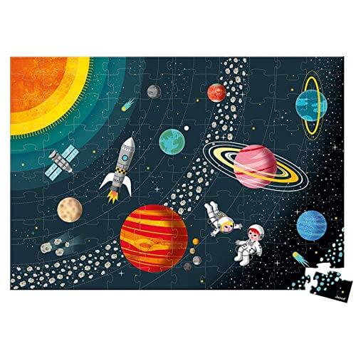 Space-themed jigsaw puzzle featuring colorful planets, a rocket, and astronauts. One piece is detached at the bottom.
