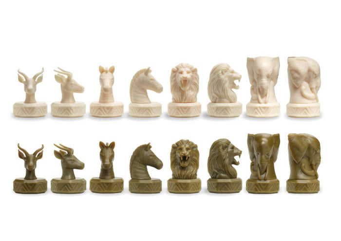Cream and olive green game pieces shaped like animal heads: lions, elephants, zebras, and gazelles on carved bases.