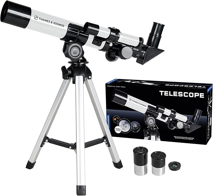 White and black Thames & Kosmos telescope on a silver tripod with two eyepieces and its product box.