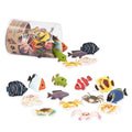 Small colorful toy tropical fish and crabs spilling out of a clear plastic tube container.