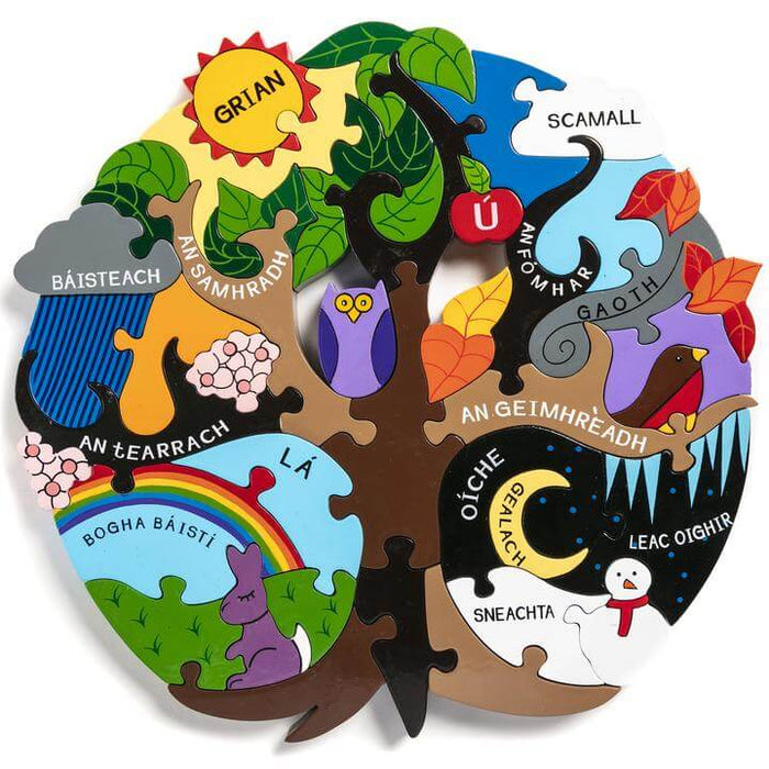 Tree-shaped wooden puzzle with four colorful seasons labeled in Irish, featuring a sun, rainbow, owl, and snowman.
