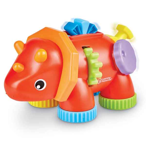Orange triceratops toy with yellow horns, green side gears, a blue crest, and textured blue and green feet.