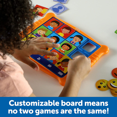 Child inserts illustrated emotion cards into an orange tablet game board with round emoji tokens nearby.